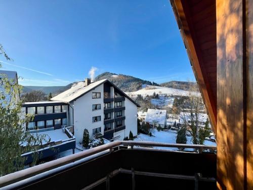 a view from a balcony of a building with snow at Goldener Hahn B&B Baiersbronn - Ferienwohnungen mit Hygge Pool & Sauna in Baiersbronn