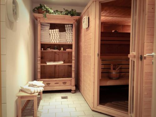 a closet with a wooden cabinet in a room at Ferienwohnungen Evi Huber in Oberammergau
