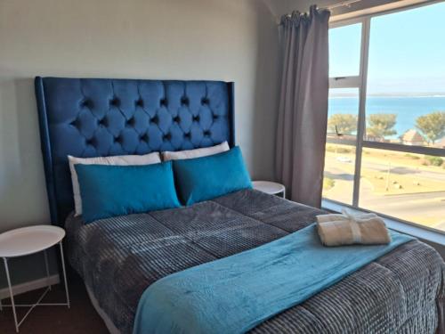 En eller flere senge i et værelse på Villa Chanel Beach Apartment