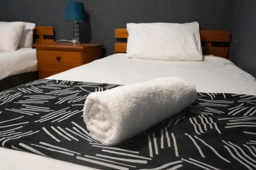 a towel on a bed in a hotel room at Seagull Apartment -2 Bedroom Apartment 408 by First Private Stays in Margate