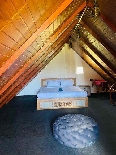 a bedroom with a bed in a attic at Freedom Peak Cabin Ambewela in Nuwara Eliya