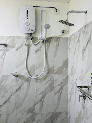 a white shower in a bathroom with marble walls at Freedom Peak Cabin Ambewela in Nuwara Eliya