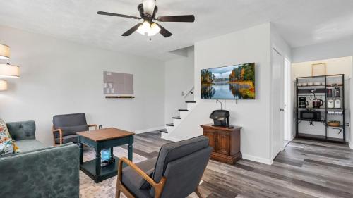 a living room with a couch and a ceiling fan at Hearth Home Brick Oven Karaoke 4 Bedroom fits 8 in Columbus