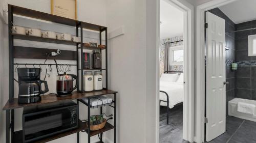 a kitchen with a microwave and a room with a bed at Hearth Home Brick Oven Karaoke 4 Bedroom fits 8 in Columbus