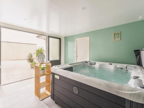 a large bathroom with a large soaking tub at Gîte spacieux avec jardin, spa, babyfoot et parking privé - FR-1-306-1292 in La Haie-Fouassière