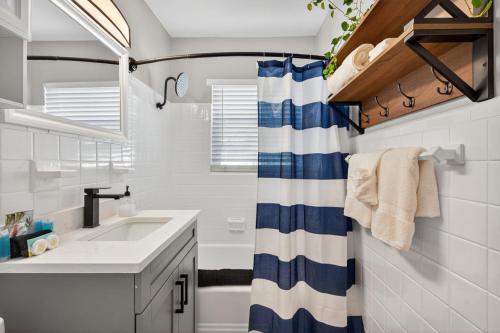 a bathroom with a sink and a shower curtain at Park Shore Suites Unit 6 in St. Pete Beach