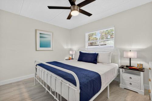 a bedroom with a bed and a ceiling fan at Sunset Beach Suites Unit 4 in St. Pete Beach