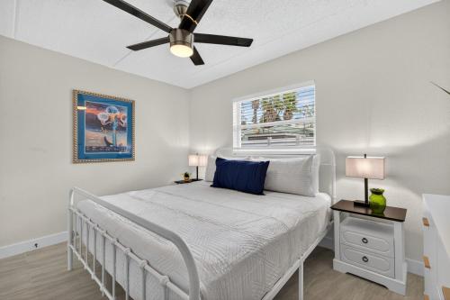 a bedroom with a bed with a ceiling fan at Sunset Beach Suites Unit 3 in St. Pete Beach
