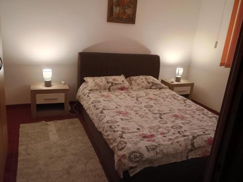 a bedroom with a bed with two night stands at Apartament Central in Piatra Neamţ