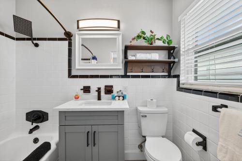 a bathroom with a sink and a toilet and a tub at Park Shores Suites Unit 9 in St Pete Beach