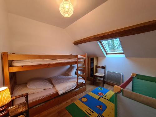 a bedroom with two bunk beds in a attic at Ferme rénovée au calme avec internet et grand espace extérieur - FR-1-591-149 in Palluau-sur-Indre