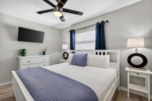a bedroom with a bed and a ceiling fan at Sunset Beach Suites Unit 6 in St. Pete Beach