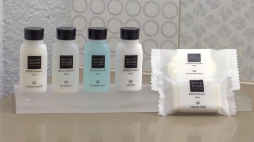 a group of three bottles of moisturizers on a shelf at Country Inn & Suites by Radisson, Mesa, AZ in Mesa
