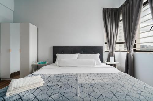 a bedroom with a large white bed and a window at The One by Nakza Stays, Lakeview Suites at Putrajaya in Putrajaya