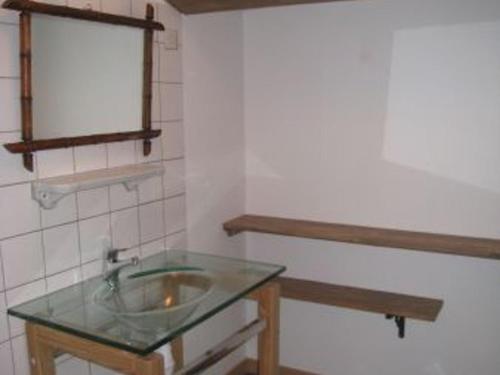 a bathroom with a sink and a mirror at Gîte rénové avec terrasse près de Nancy - Calme et charme garanti - FR-1-584-35 in Tonnoy