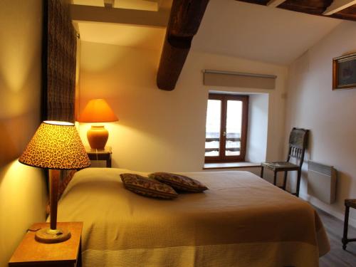 a bedroom with a bed with a lamp and a window at Gîte Charmant avec Cheminée, Terrasse et Stationnement - Proche Nancy et Moselle - FR-1-584-50 in Tonnoy