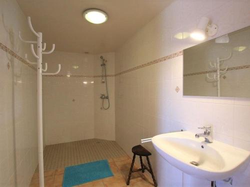 a white bathroom with a sink and a shower at Gîte en pierre avec terrasses, proche de sites médiévaux, idéal pour famille avec équipements bébé. - FR-1-582-256 in Boisset