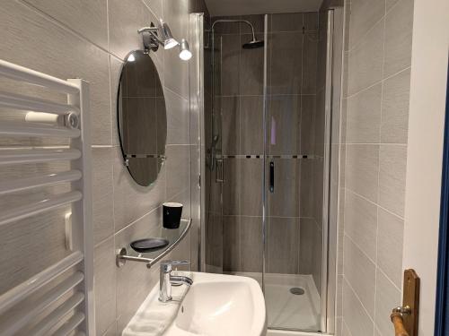 a bathroom with a sink and a shower at Maison cosy à Sully-sur-Loire, 5 chambres, terrasse, parking, draps et chauffage inclus - FR-1-590-220 in Sully-sur-Loire