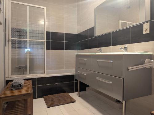 a bathroom with a sink and a mirror and a tub at Élégante maison de maître XVIIIe, jardin clos 500m², nature, proche Puy-en-Velay, 11 pers., cosy & confort - FR-1-582-315 in Arsac-en-Velay