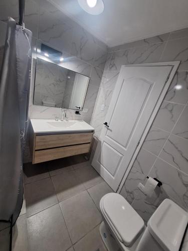 a bathroom with a sink and a toilet at Casa Clara in Tandil