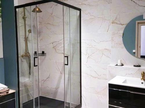 a shower with a glass door in a bathroom at Chambre Royale au Château de la Rose avec Parking Privé - FR-1-591-766 in Cluis