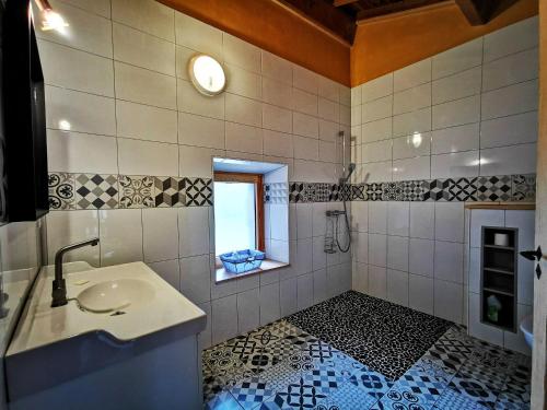 a bathroom with a sink and a window at Gîte confortable près de la Cascade de la Beaume avec terrasses et parking privatif - FR-1-582-30 in Solignac-sur-Loire