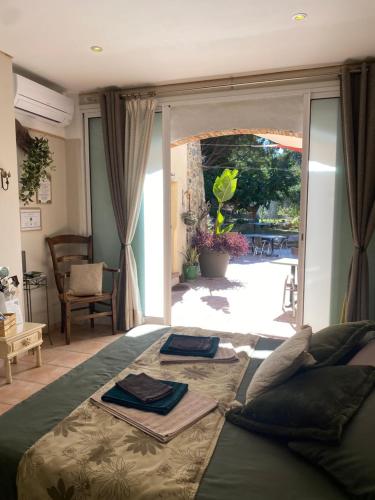 a bedroom with a bed and a sliding glass door at "MAS TRAMONTANE" Maison et Chambres d'hôtes avec vue sur le massif d'El Canigó in Ille-sur-Têt