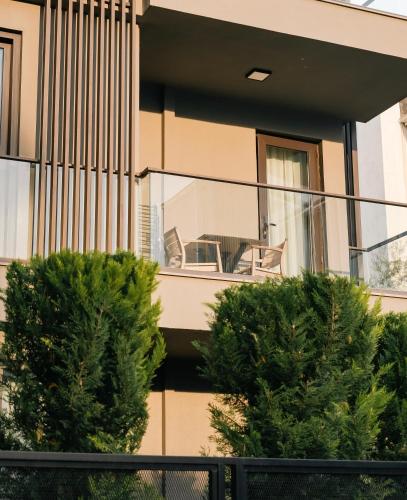 a house with a balcony with a table and chairs at Vesta Rooms in Antalya
