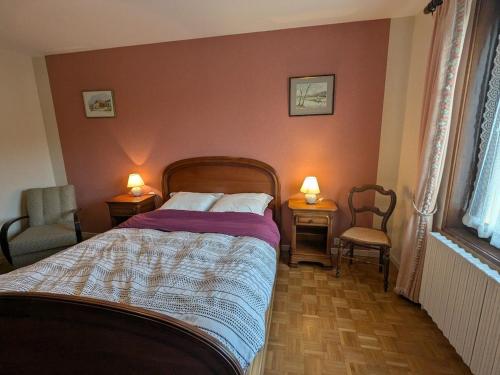 a bedroom with a bed with two chairs and two lamps at Chambres d'hôtes familiales à Vecoux, nature et activités - FR-1-589-739 in Vecoux