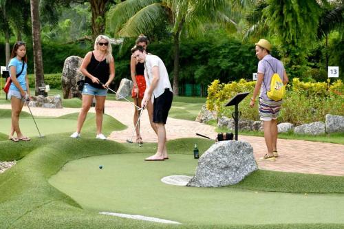 a group of people playing golf on a putting green at DANK Hotel 420 friendly Patong Phuket in Patong Beach