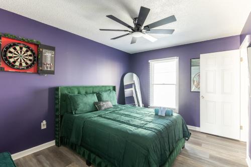 a bedroom with a bed and a dartboard on the wall at BoardGame Bungalow in Atlantic City