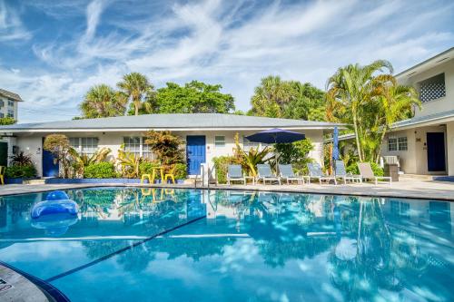 a swimming pool in front of a house at Casa Cordova Apartments By Lowkl in Fort Lauderdale