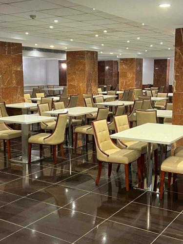 a dining room with tables and chairs in a building at Grand Cleopatra Hotel-Luxor in Luxor
