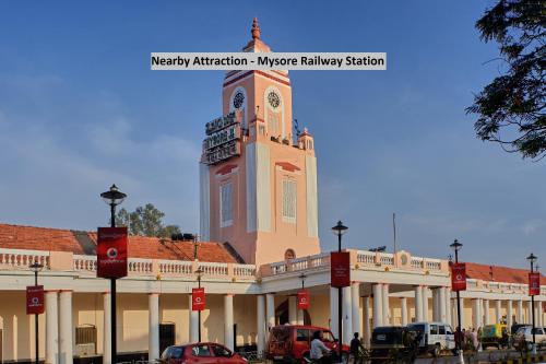 a building with a clock tower on top of it at Hotel O Eagle Fantasy in Vānivilāsa Puram