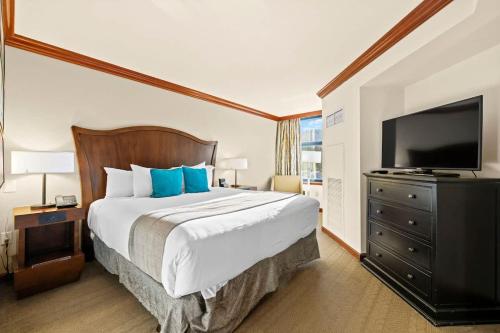 a bedroom with a large bed and a flat screen tv at 6th Floor Fireplace Suite in Tahoe City