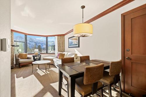 a living room with a dining table and a couch at 6th Floor Mountain View Room - Fireplace Suite in Tahoe City