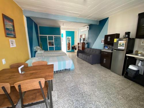 a bedroom with a bed and a table and a couch at Casa Magro depto para 6 in Oaxaca City