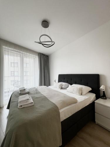 a bedroom with a large bed with towels on it at MT Suites ApartHotel in Budapest
