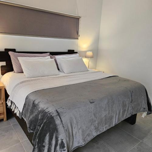 a bedroom with a large bed with a large headboard at Atlantis in Hentiesbaai