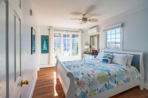 a bedroom with a bed and a window at Blue Ocean Cove Beach House in Saint Peters