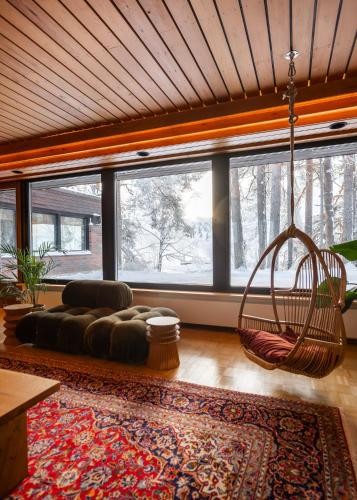 a living room with a couch and a swing at Villa Amara & Private Spa in Rovaniemi