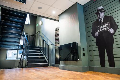 a large painting of a man in a hat on a wall at Duke Street Boutique Hotel in Liverpool