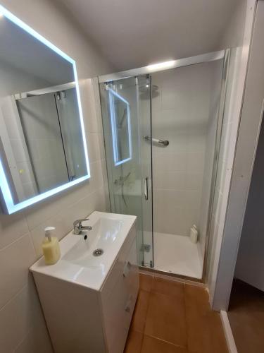 a white bathroom with a shower and a sink at playa y naturaleza in Matalascañas