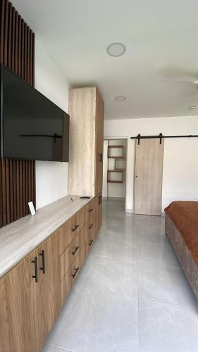 a large room with a television and a bed at Montería, MonteCapi in Montería
