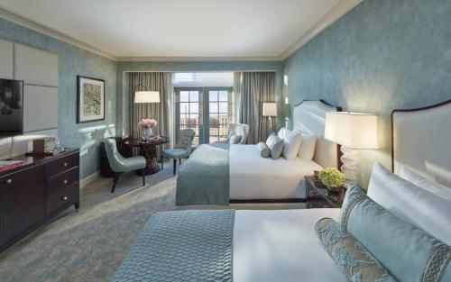 a large hotel room with a bed and a desk at Salamander Washington DC in Washington, D.C.