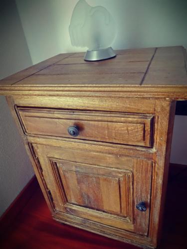a wooden nightstand with a lamp on top of it at Casale del Sole in Cepagatti
