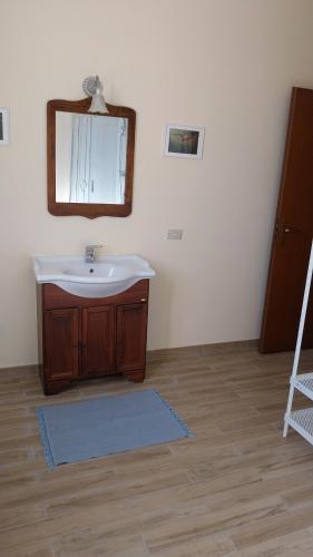 a bathroom with a sink and a mirror at Tenuta Rio del Sole-Appartamento in Albairate