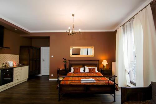 a bedroom with a bed and a chandelier at Apartamenty Młynowa in Białystok