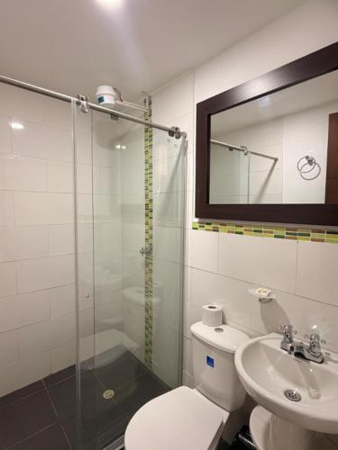 a bathroom with a shower and a toilet and a sink at HOTEL RIVERA CENTRAL in Bucaramanga