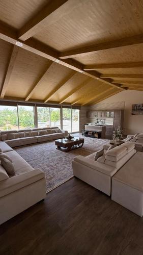 a large living room with couches and a table at Sun Set Dunes Holidays Home